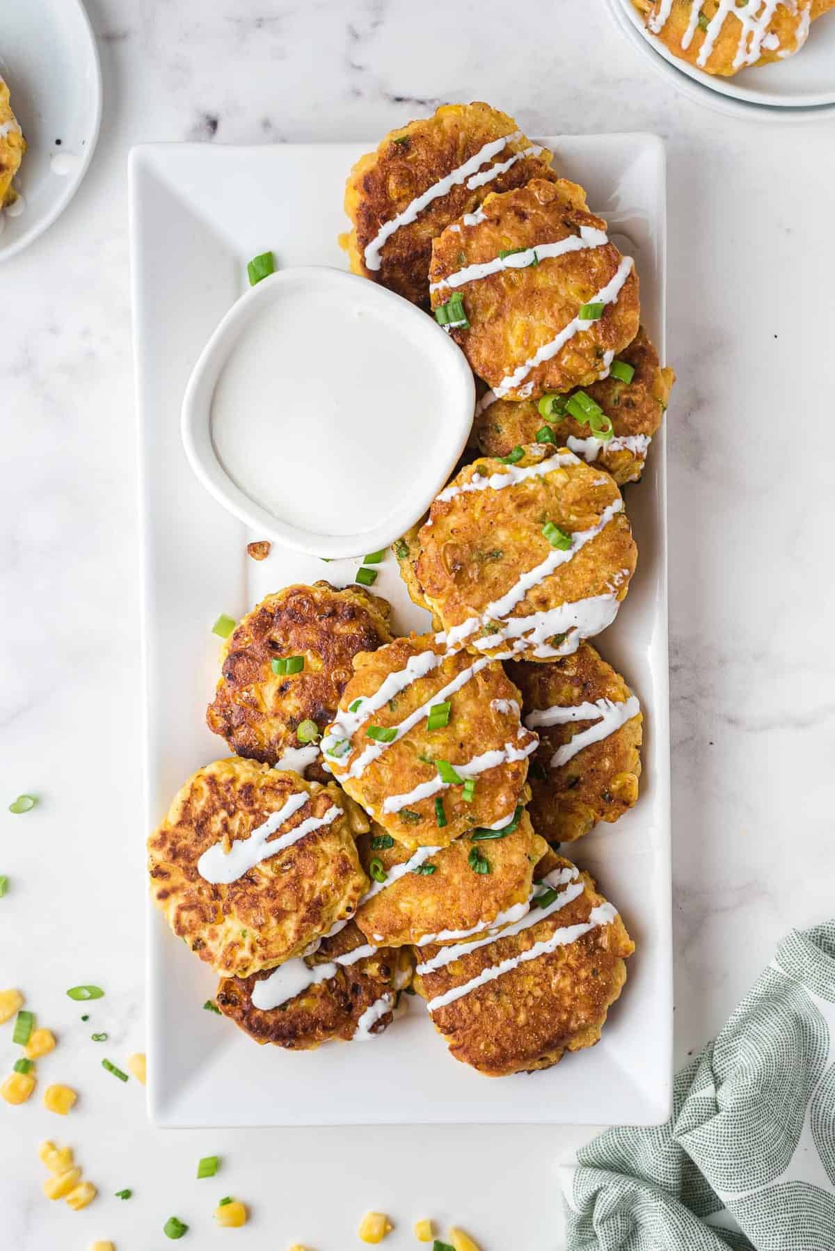 Vista aérea de panqueques de maíz rociados con crema agria.